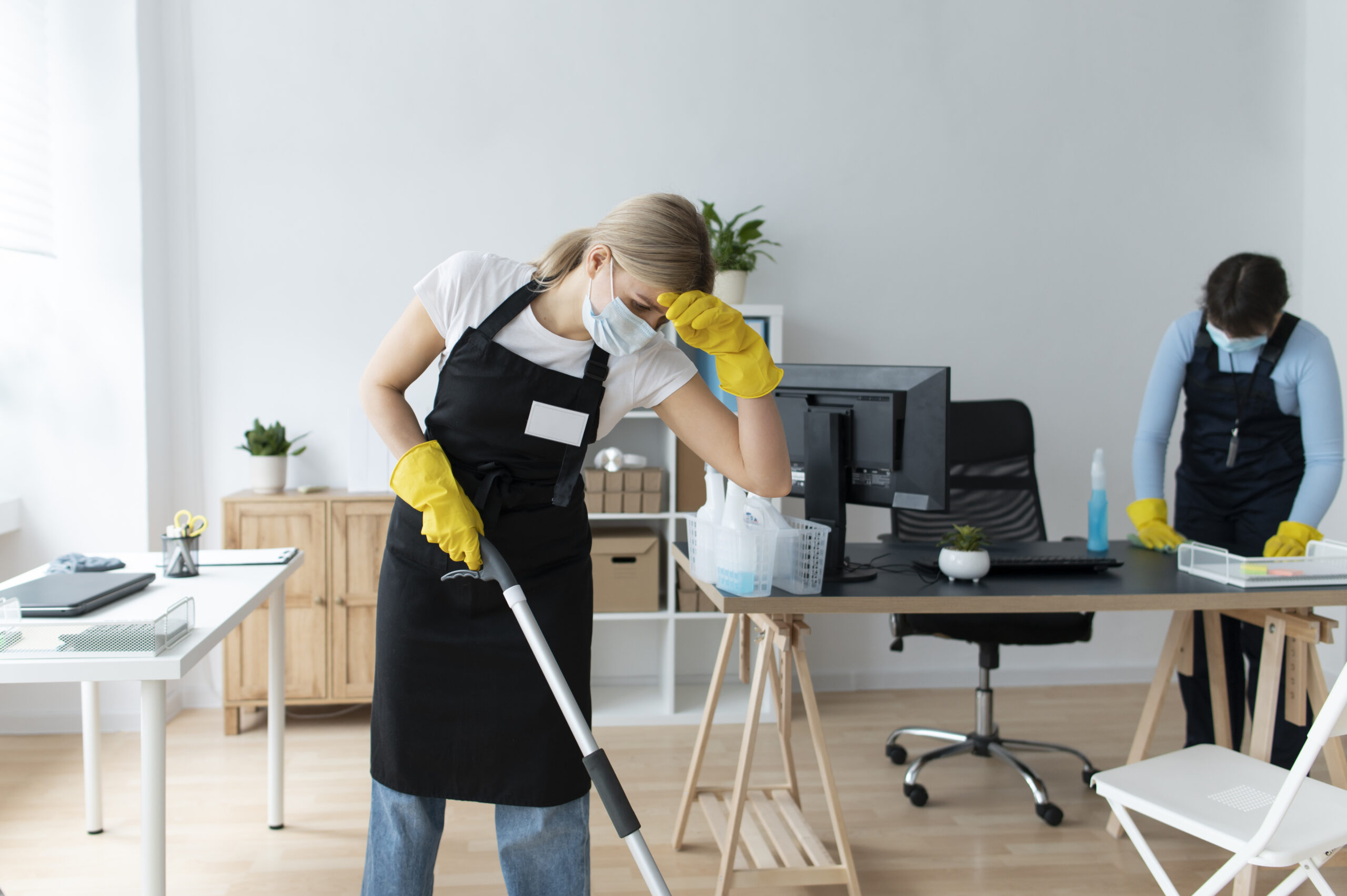 Professional office cleaner working in a bright office in Manchester